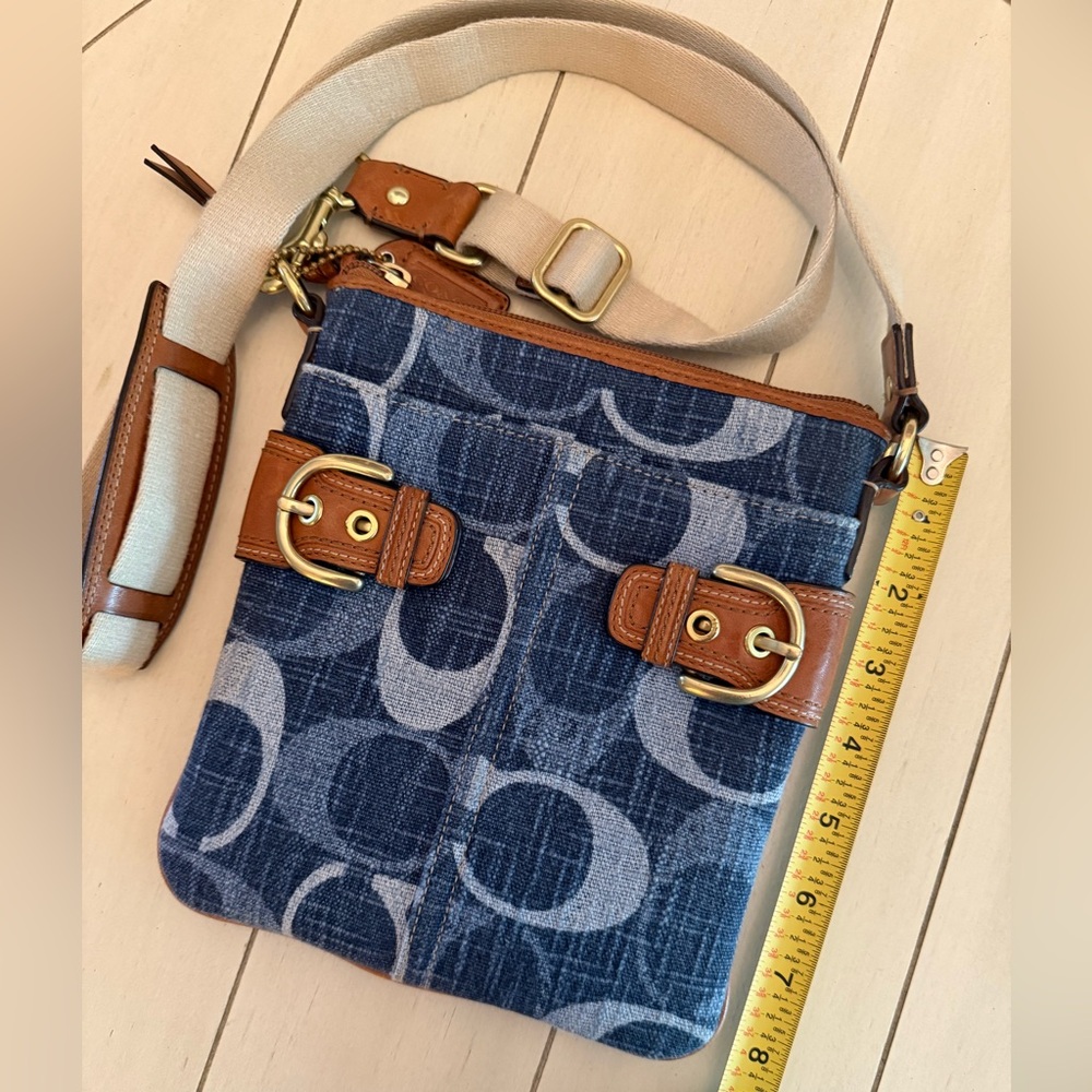 Denim Coach crossbody with zipper closure and front and back slip pockets